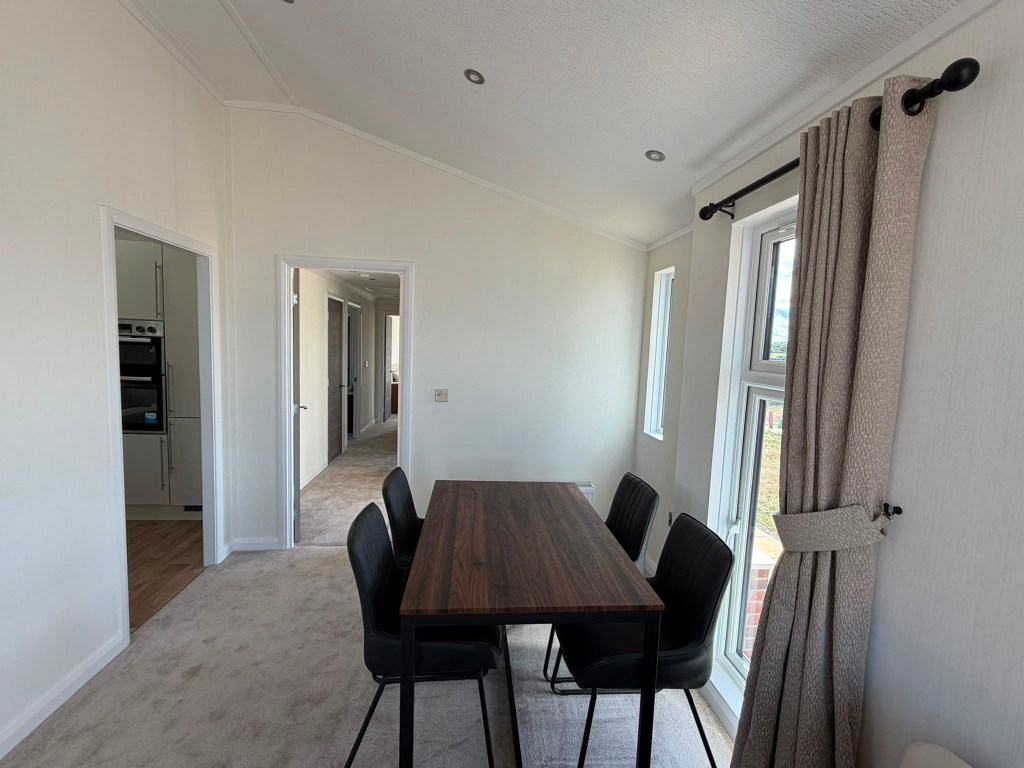 Utility kitchen area with cream units and walnut worktop — Stately Wentwood lodge